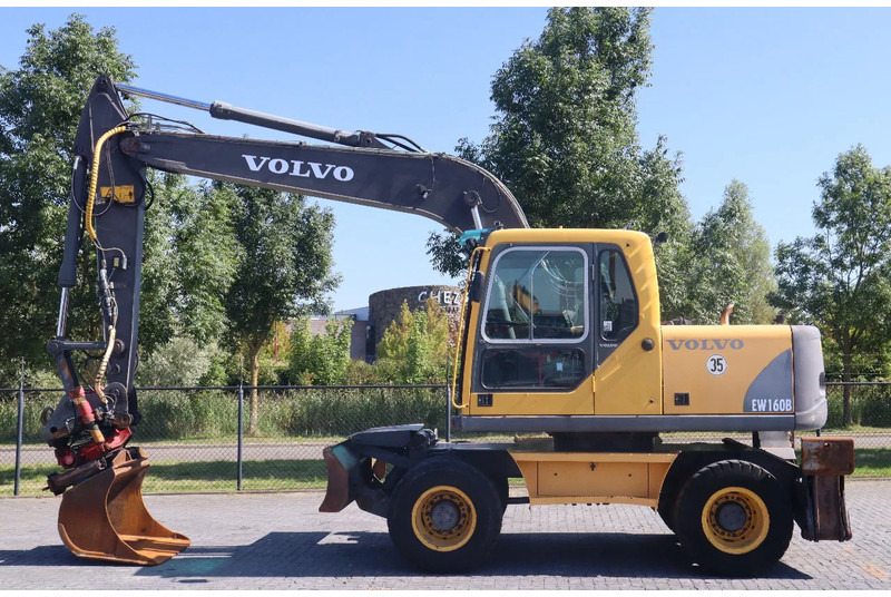 Volvo EW160B | EW 160 B | TILT ROTATOR | BUCKET | OUTRIGGERS | BLADE - Escavadeira de rodas: foto 1 Volvo EW160B | EW 160 B | TILT ROTATOR | BUCKET | OUTRIGGERS | BLADE - Escavadeira de rodas: foto 1