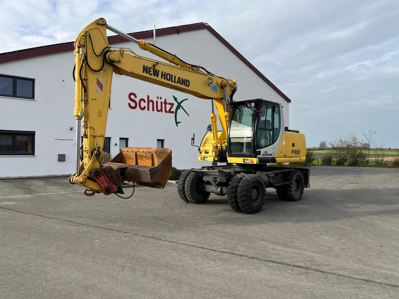 New Holland MH 5.6 inkl. Grabenlöffel, Tieflöffel - Escavadeira de rodas: foto 1 New Holland MH 5.6 inkl. Grabenlöffel, Tieflöffel - Escavadeira de rodas: foto 1