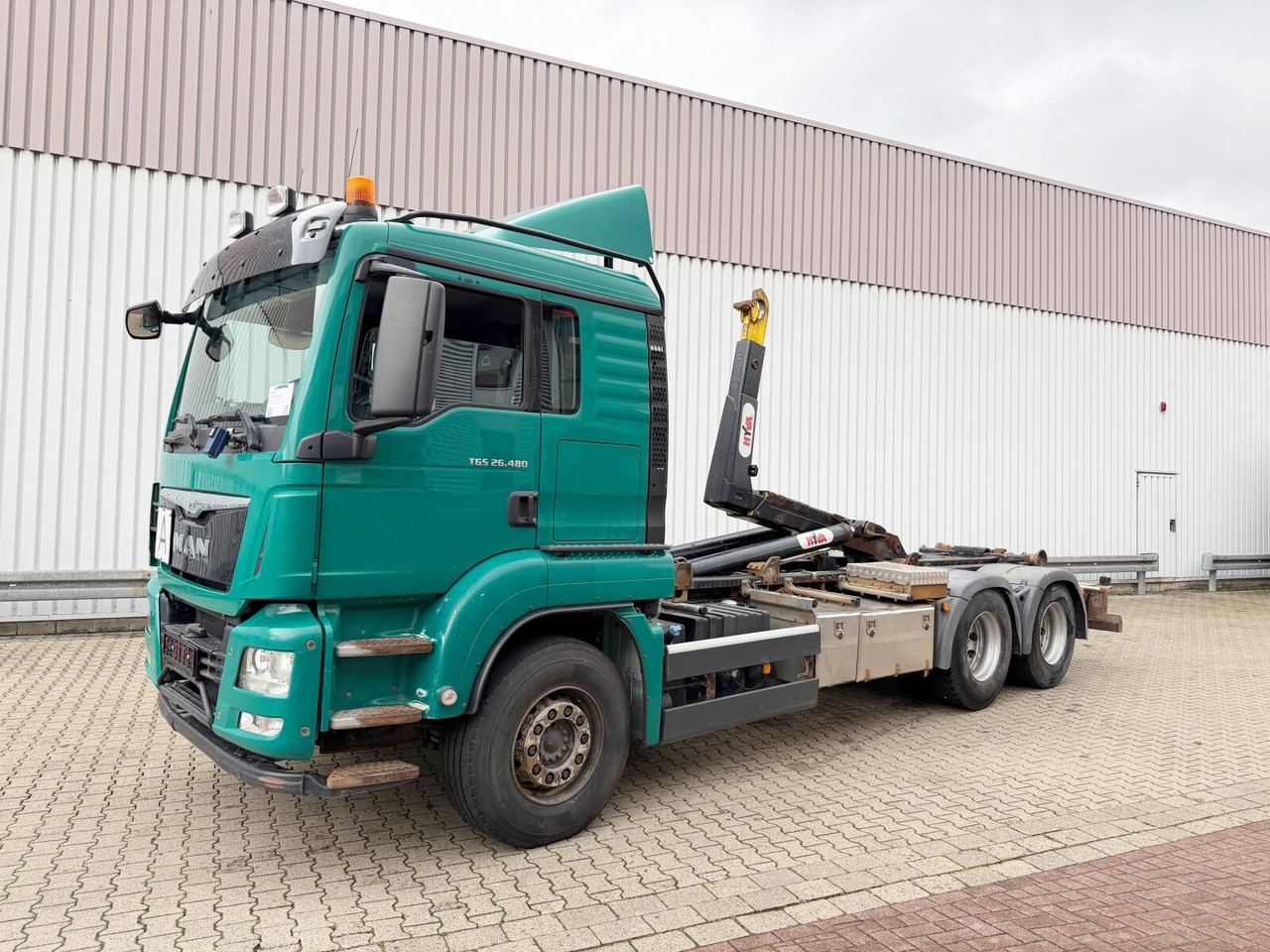 MAN TGS 26.480 6x4 BL TGS 26.480 6x4 BL, Motorabtrieb, Navi, Intarder, Hyva 20.60 S - Camião polibenne: foto 1 MAN TGS 26.480 6x4 BL TGS 26.480 6x4 BL, Motorabtrieb, Navi, Intarder, Hyva 20.60 S - Camião polibenne: foto 1