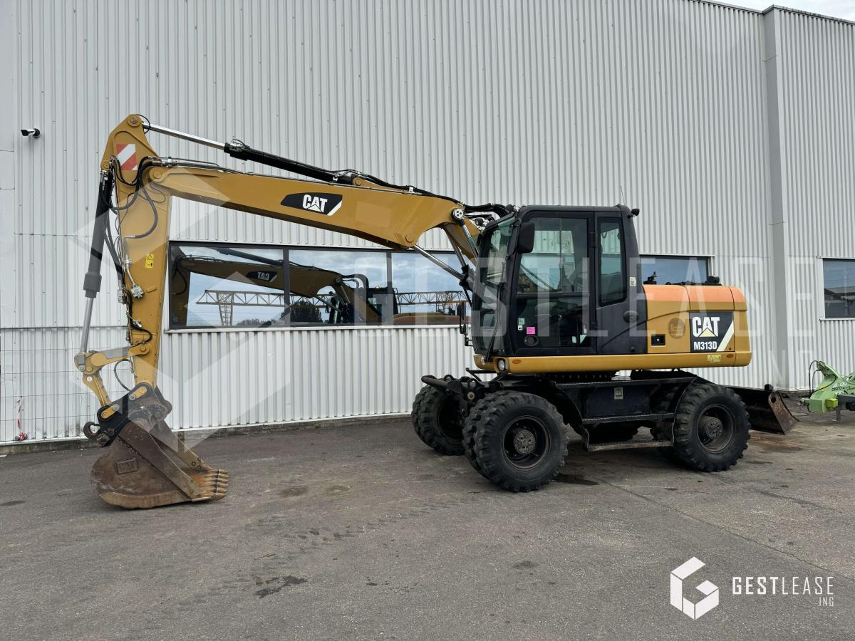 Caterpillar M313D - Escavadeira de rodas: foto 1 Caterpillar M313D - Escavadeira de rodas: foto 1