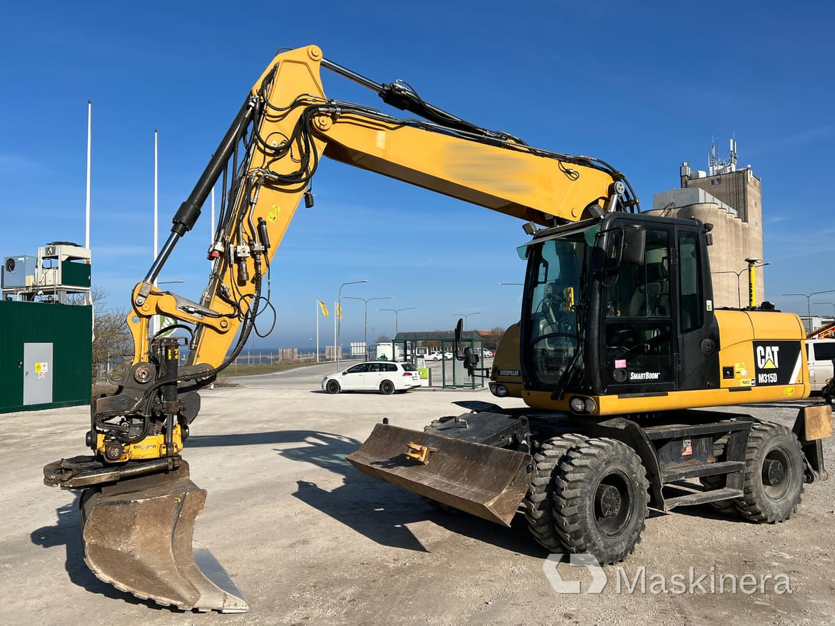 Hjulgrävare CAT 315D med tillbehör - Escavadora de rastos: foto 1 Hjulgrävare CAT 315D med tillbehör - Escavadora de rastos: foto 1