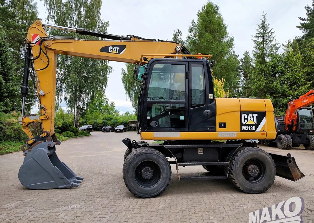 Caterpillar M313D - Escavadeira de rodas: foto 1 Caterpillar M313D - Escavadeira de rodas: foto 1