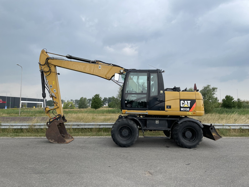 Caterpillar M313D - CE - Escavadeira de rodas: foto 1 Caterpillar M313D - CE - Escavadeira de rodas: foto 1