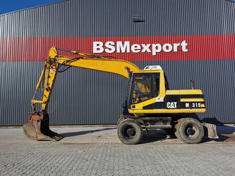Caterpillar M315 wheel excavator - Escavadeira de rodas: foto 1 Caterpillar M315 wheel excavator - Escavadeira de rodas: foto 1