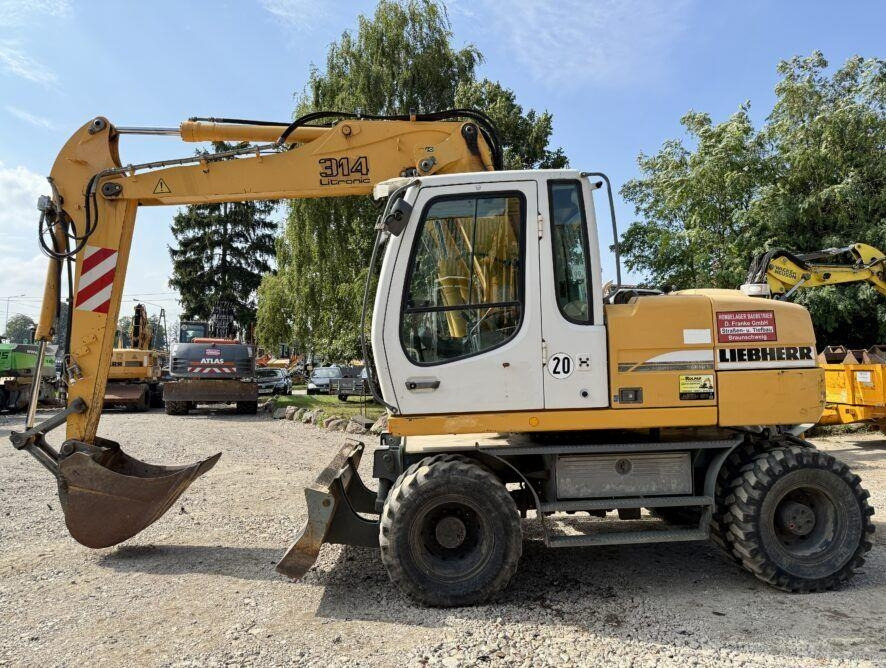 Liebherr A314 - Escavadeira de rodas: foto 1 Liebherr A314 - Escavadeira de rodas: foto 1