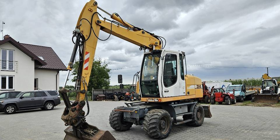 Koparka kołowa Liebherr A314 Litronic 9350 h 4 łyżki kołówka - Escavadeira de rodas: foto 2 Koparka kołowa Liebherr A314 Litronic 9350 h 4 łyżki kołówka - Escavadeira de rodas: foto 2