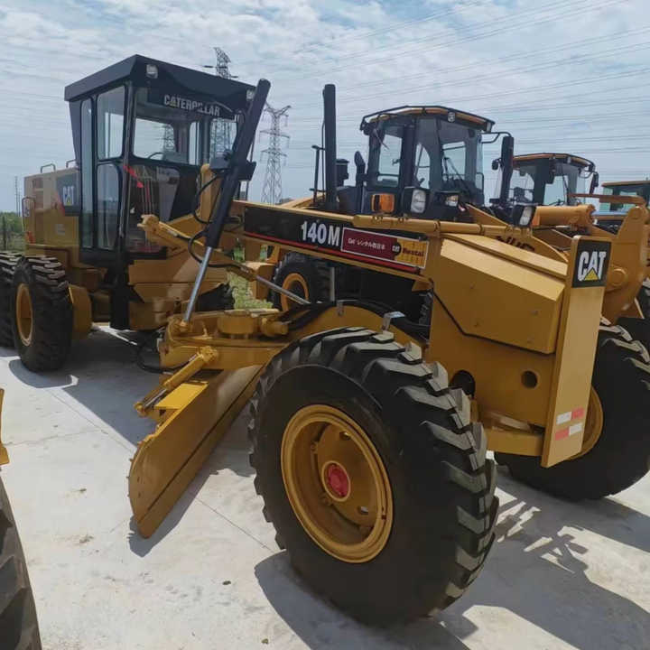 Used Japan Imported Caterpillar 140M Cat 140m Motor Grader with Good Quality and Low Price for Sale - Escavadora de rastos: foto 1 Used Japan Imported Caterpillar 140M Cat 140m Motor Grader with Good Quality and Low Price for Sale - Escavadora de rastos: foto 1