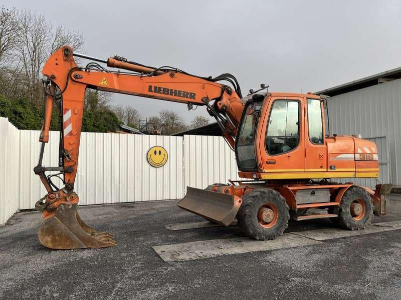 Liebherr A316 LITRONIC - Escavadeira de rodas: foto 1 Liebherr A316 LITRONIC - Escavadeira de rodas: foto 1