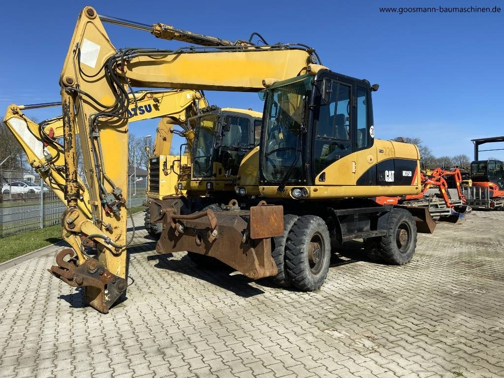 CAT M 315D - Escavadeira de rodas: foto 1 CAT M 315D - Escavadeira de rodas: foto 1