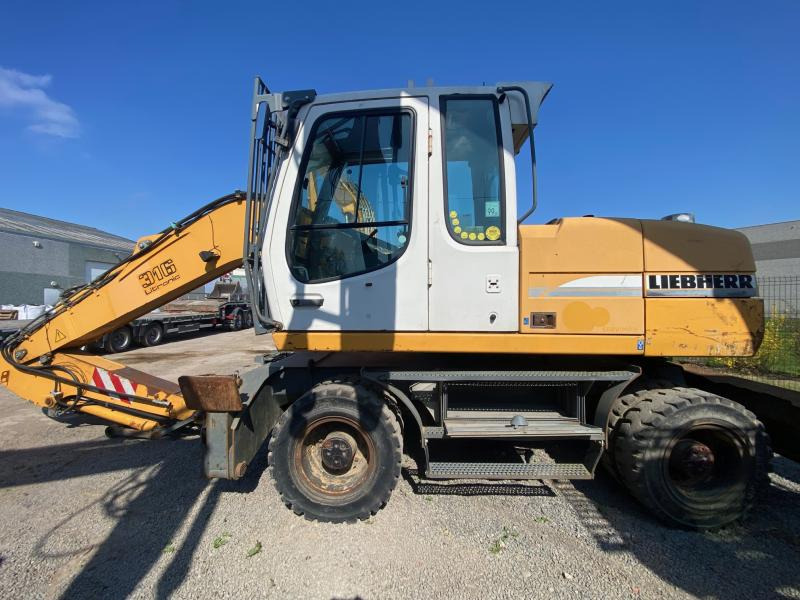 Liebherr A316Litronic - Escavadeira de rodas: foto 1 Liebherr A316Litronic - Escavadeira de rodas: foto 1